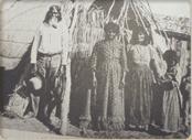 1903, A Tachi Yokut family stands in front
of their Tule mat house near the Village 
of Wiu ... now the Santa Rosa Rancheria